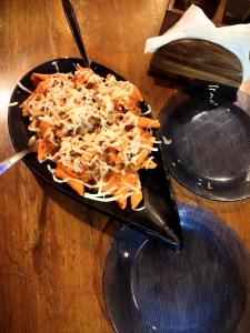 a plate of food on a table with a plate of pasta at Hotel Lake Bridge in Udaipur