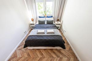 two beds in a small room with a window at Garone in Gdańsk