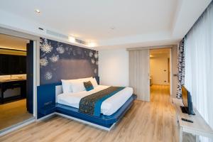 a bedroom with a large bed in a room at Bhukitta Boutique Hotel Phuket Town in Phuket +31 photos