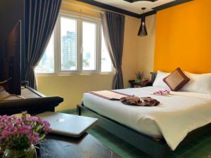 um quarto com uma cama, um computador portátil e uma janela em Ipeace Hotel - Bùi Viện Walking Street em Ho Chi Minh