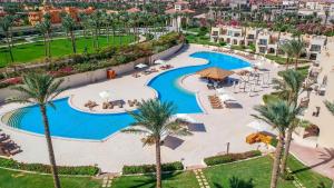 an aerial view of a resort pool with palm trees at Cleopatra Luxury Resort Sharm El Sheikh in Sharm El Sheikh