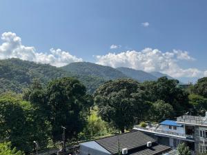a view of a mountain with trees and a building at Trekkers Lodge in Pokhara