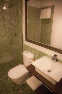a bathroom with a toilet and a sink and a shower at Luxor 7 in Seville