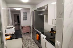 a kitchen with a refrigerator and a stove top oven at RELAX Sólo familias in Bellreguart