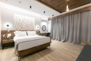 a bedroom with a king sized bed and a table at ridos house in Neos Marmaras