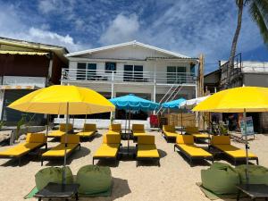 a group of yellow chairs and umbrellas on the beach at Pi3 Beach Resort in Lamai