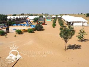 a view of a resort with a pool and a beach at Queen of Thar Desert Camp in Sām
