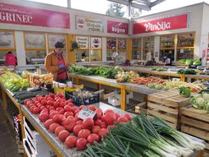 a person standing in a produce section of a market at OAK COTTAGE in Maruševec