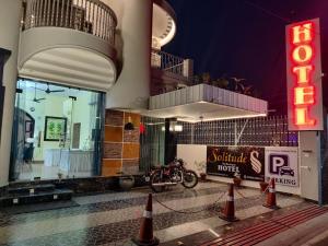 a motorcycle parked outside of a hotel at night at Solitude, The Boutique Hotel in Haldwāni