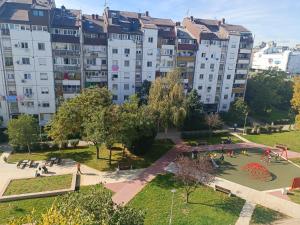 an apartment building with a park in front of it at Serbian home in Belgrade