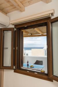 a window in a room with a view of the ocean at Elizabeth's small apartment in Naxos Chora