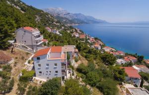 a group of houses on a hill next to the water at Villa Anči in Pisak