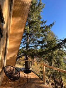 a patio with a table and chairs on a porch at Hovanka in Yaremche