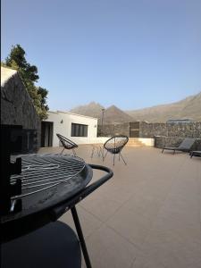 a group of chairs sitting on top of a patio at BUNGALOW APARTAMENTO SOL in Famara