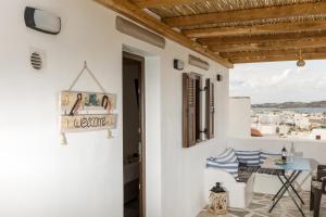a room with white walls and a table and chairs at Elizabeth's small apartment in Naxos Chora