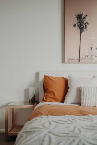 a bedroom with a bed and a table and a picture at House on Hampson in Penguin