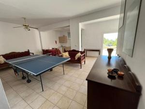 a living room with a ping pong table in it at Villa Armonia in Crete, quiet with sea view & pool in Xirostérnion