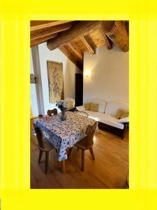a dining room with a table and a bed at Chalet Blanc "La Mansarda" in Courmayeur