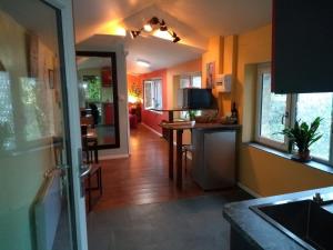 a kitchen with yellow walls and a dining room at Maison Chopin in Gramat