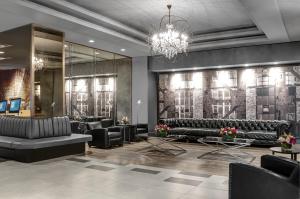 a lobby with black furniture and a chandelier at The Manhattan at Times Square in New York