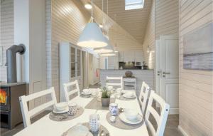 a dining room with a white table and chairs at Haus Otter in Göls