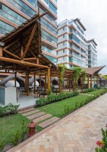 a pavilion with tables and chairs in front of a building at Apto Joao Pessoa/Cabedelo in Cabedelo