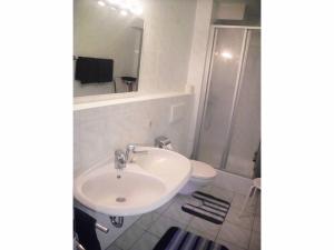 a bathroom with a sink and a shower and a toilet at Appartementhaus Viktoria in Bad Birnbach +10 photos