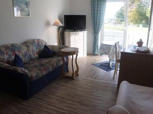 a living room with a couch and a table at Appartementhaus Viktoria in Bad Birnbach