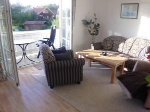 a living room with couches and a coffee table at Appartementhaus Viktoria in Bad Birnbach