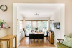 a dining room and living room with a table and chairs at Eighteen Whitstable 4 parking spaces in Kent