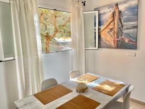 a dining room with a table and a window at Casa Nube in Sant Francesc Xavier