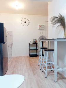 a kitchen with a counter and stools in a room at Cabuhat Duco Lodge 2 in Naic +14 photos