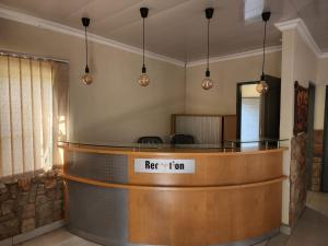 a bar in a waiting room with a reception desk at Bela Rest Resort in Bela-Bela