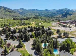 an aerial view of a resort with trees and a pool at Red Pine Mountain Retreat steps from the Cabriolet in Park City