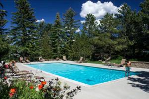 a swimming pool with a person standing next to it at Red Pine Mountain Retreat steps from the Cabriolet in Park City