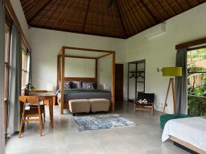 a bedroom with a bed with a large mirror at Uma Mupu Retreat in Gianyar
