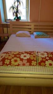 a bed with two pillows on it in a bedroom at BalticApart Riga in Rīga