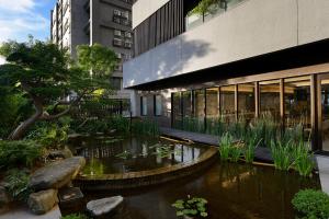 a koi pond in front of a building at Joyfultel in Guishan