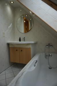 a bathroom with a bath tub and a sink at Apartment mit Ausblick im Dresdner Südwesten in Dresden