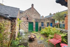 a garden with a fire pit in a brick building at No 9 The Hill Cromford Nr Matlock Bath in Cromford