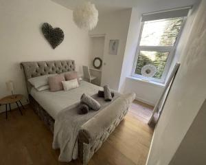a bedroom with a bed with two pillows on it at Dunoon River Clyde Flat in Innellan