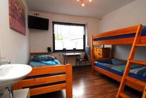 a bedroom with two bunk beds and a sink at Monteurzimmer Krings Baptistastr 2a in Eschweiler +30 photos