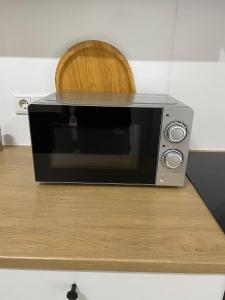 a microwave sitting on top of a wooden counter at Place to sleep - Kassel: Direkt an der Uni in Kassel