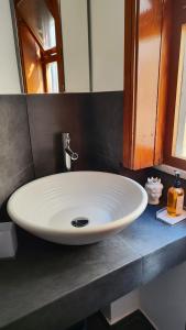 a white sink in a bathroom with a mirror at Torre dei Pirati in Letojanni