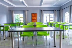 a room filled with tables and green chairs at Bela Rest Resort in Bela-Bela +105 photos