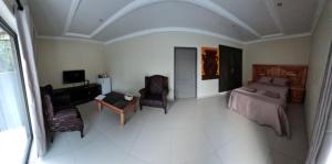 a living room with a couch and a table at Bela Rest Resort in Bela-Bela