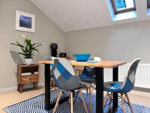 a dining room with a table and four chairs at River Vista Retreat - Luxury duplex Apt - Views - Parking - Cycle storage - Spa access option in Backbarrow +65 photos