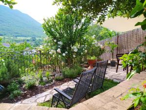 a group of chairs sitting in a garden at Alloggio Agrituristico Abruzzomio - Casa Somarello in Goriano Valli