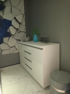 a room with a white cabinet and a wall at APARTAMENT KOSMOS GORZOW in Gorzów Wielkopolski
