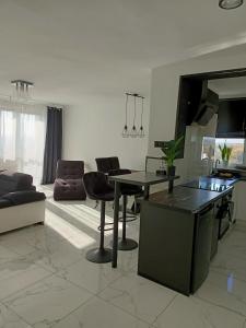 a living room with a table and a couch at APARTAMENT KOSMOS GORZOW in Gorzów Wielkopolski
